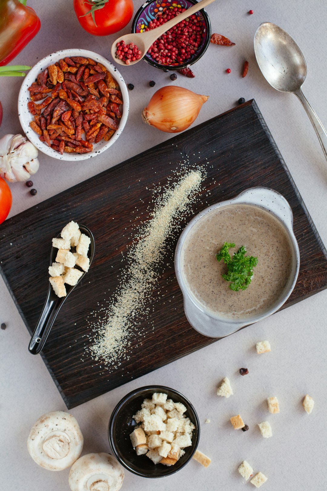 Bowl of Czech mushroom soup with autumn vegetables on a wooden table